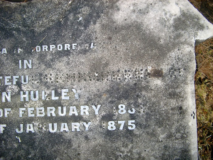 Close-up of damaged headstone
